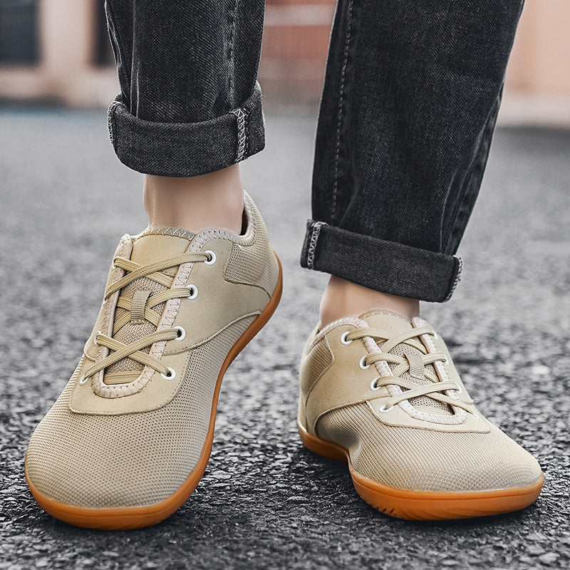 Beige casual shoes worn with rolled-up jeans