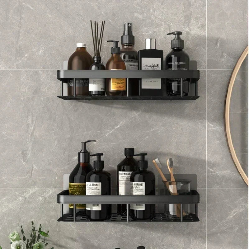 Wall-mounted shower shelves with bath products on grey tiles