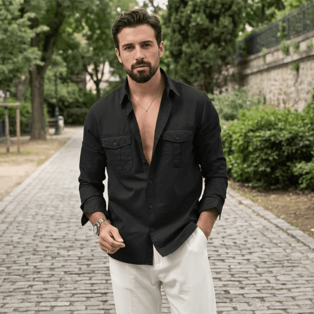 Man in a black shirt and white trousers outdoors