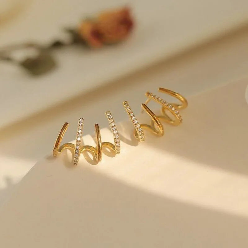 Orecchini attorcigliati — Silhouette elegante in oro o argento
