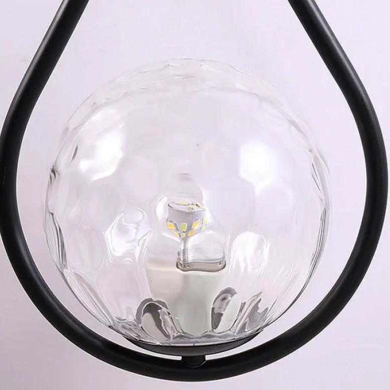 Nordisk LED-vegglampe med glasskule i svart til nattbord | boxzora
